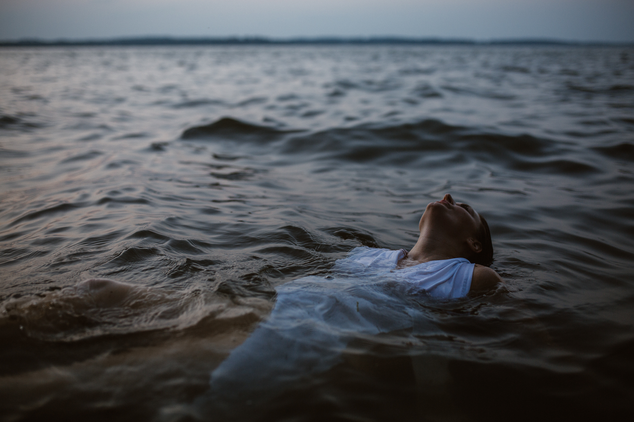 Captivating woman in an intimate lake session during a summer sunset.